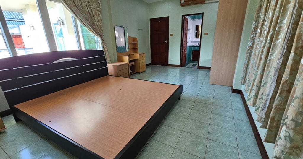 Second bedroom with ensuite access, tiled floor, air conditioning, and fitted furniture in a Phuket pool villa.