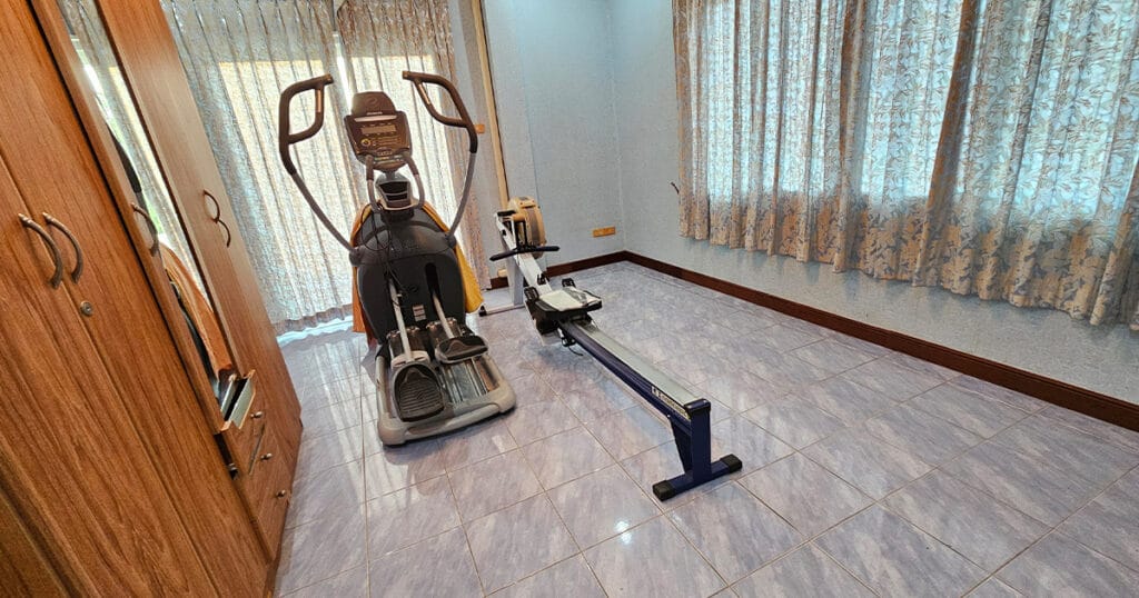 Third bedroom is currently used as a home gym with tiled flooring, natural light, and flexible space in a Phuket pool villa.