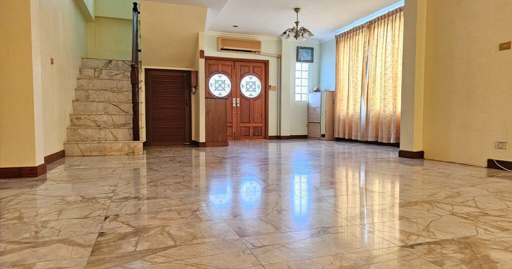 Large open-plan living area with staircases, marble tiled floors, ceiling fans, and air conditioning in a Phuket villa.