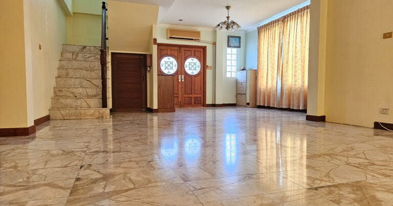 Large open-plan living area with staircases, marble tiled floors, ceiling fans, and air conditioning in a Phuket villa.